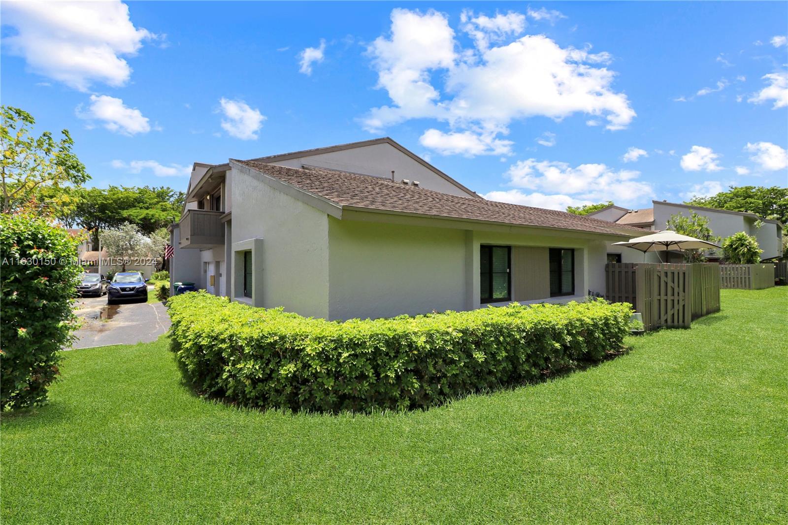 10665 Southwest 113th Place, Unit 95D Miami, FL 33176 - Photo 3 of 42 a front view of a house with garden