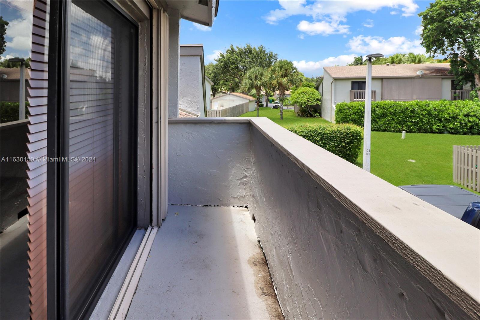 10665 Southwest 113th Place, Unit 95D Miami, FL 33176 - Photo 31 of 42 a view of a house with a porch