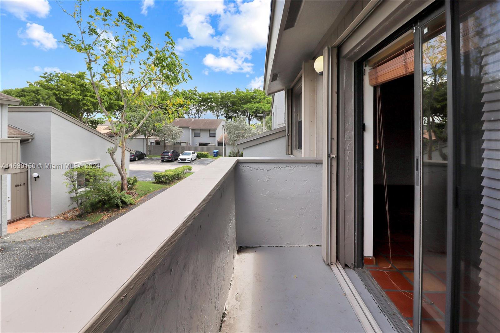 10665 Southwest 113th Place, Unit 95D Miami, FL 33176 - Photo 32 of 42 a view of balcony with furniture