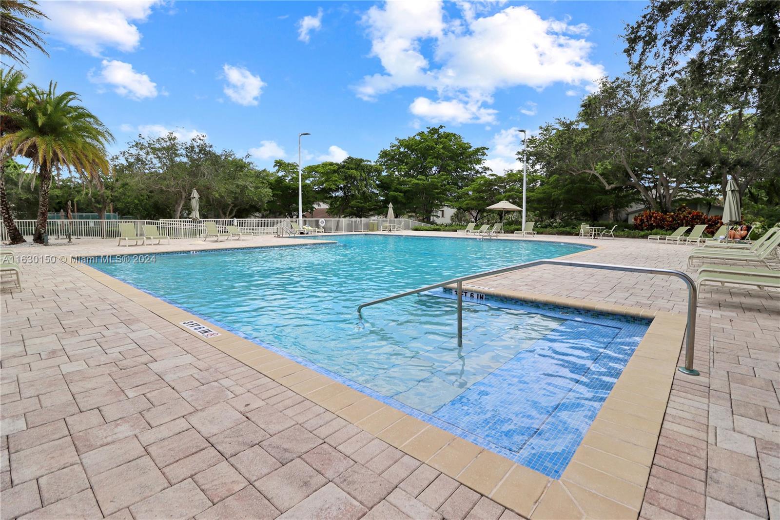10665 Southwest 113th Place, Unit 95D Miami, FL 33176 - Photo 34 of 42 a view of a swimming pool with a yard