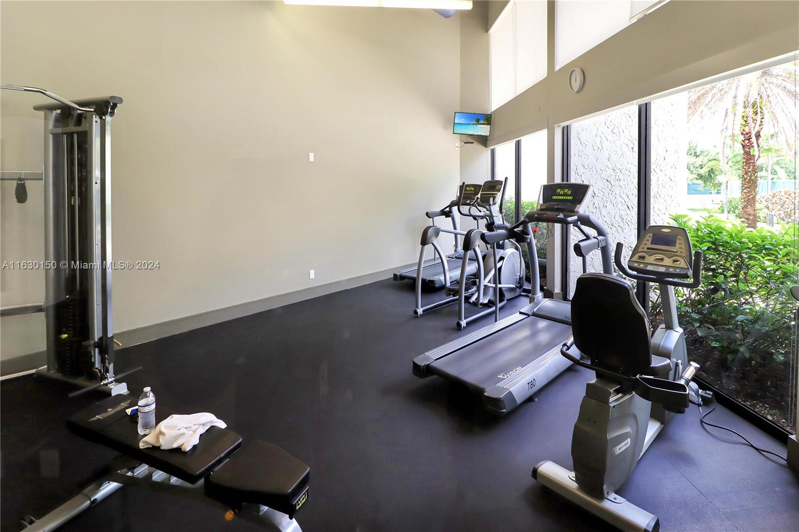 10665 Southwest 113th Place, Unit 95D Miami, FL 33176 - Photo 37 of 42 a view of a workspace with furniture and a window