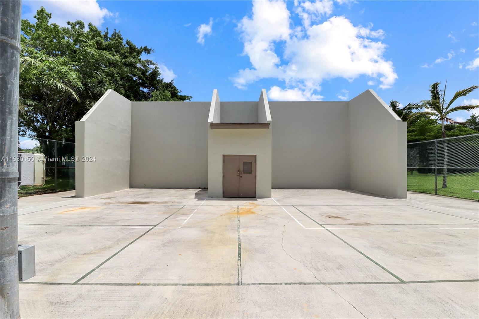 10665 Southwest 113th Place, Unit 95D Miami, FL 33176 - Photo 39 of 42 a white house with tree in front of it