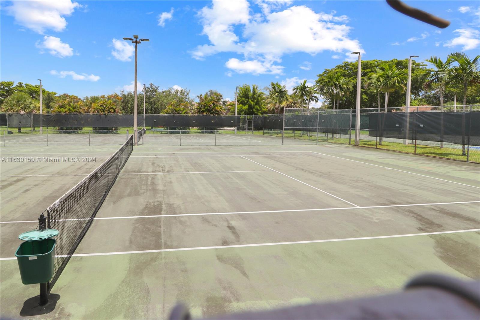 10665 Southwest 113th Place, Unit 95D Miami, FL 33176 - Photo 40 of 42 a view of a tennis court
