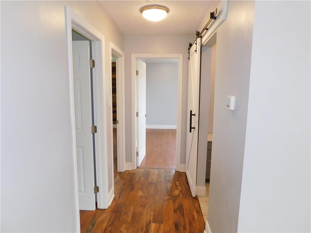 2413 Kane Road Aliquippa, PA 15001 - Photo 14 of 14 Beautiful Hallway with that the seller was accenting nicely with a brand new Sliding Barn door for the Bathroom.