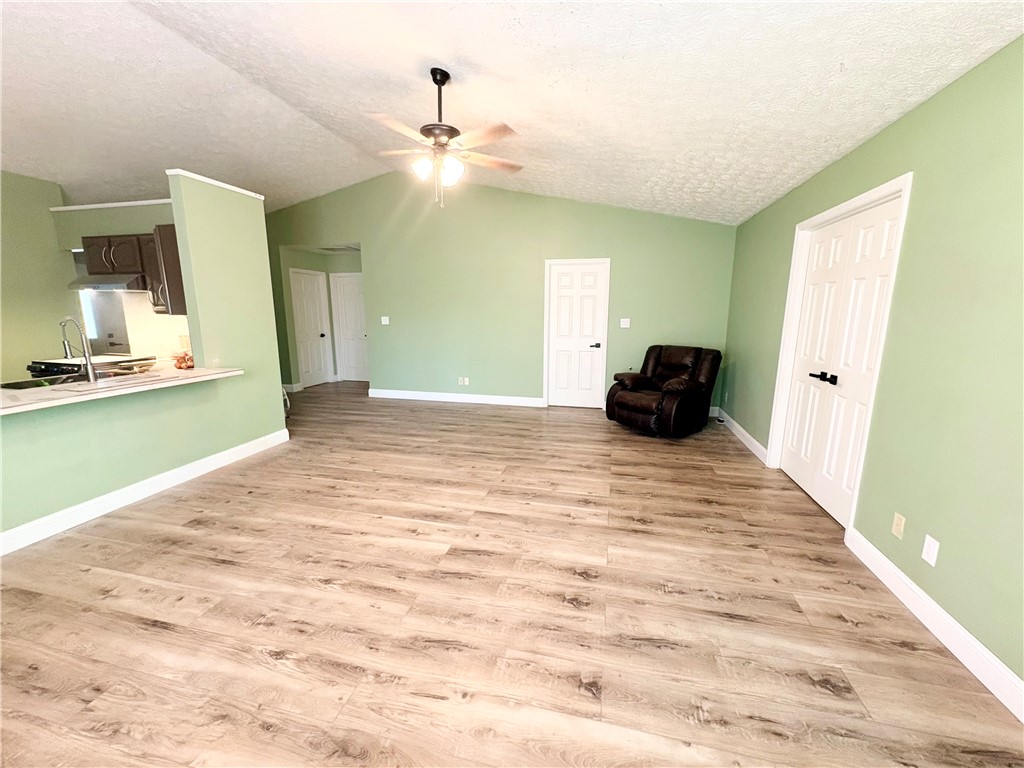 175 Marrett Farm Road Englewood, OH 45322 - Photo 11 of 29 Bright and airy living space featuring vaulted ceilings and durable flooring.