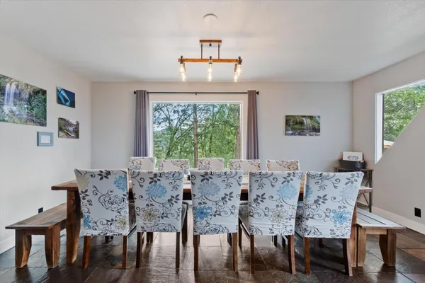 a living room with furniture and large windows
