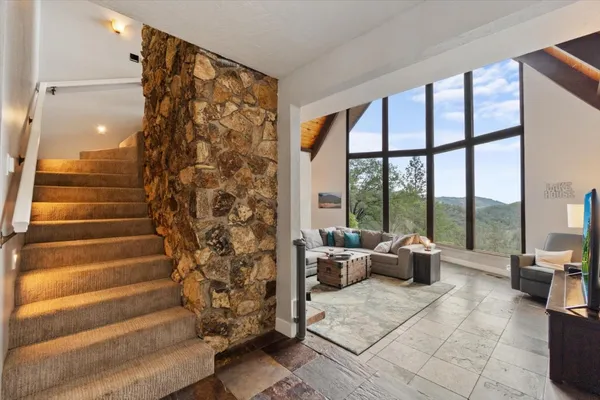 a view of a balcony with wooden floor and fence
