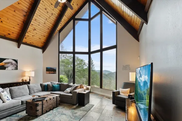 a living room with furniture a fireplace and a table