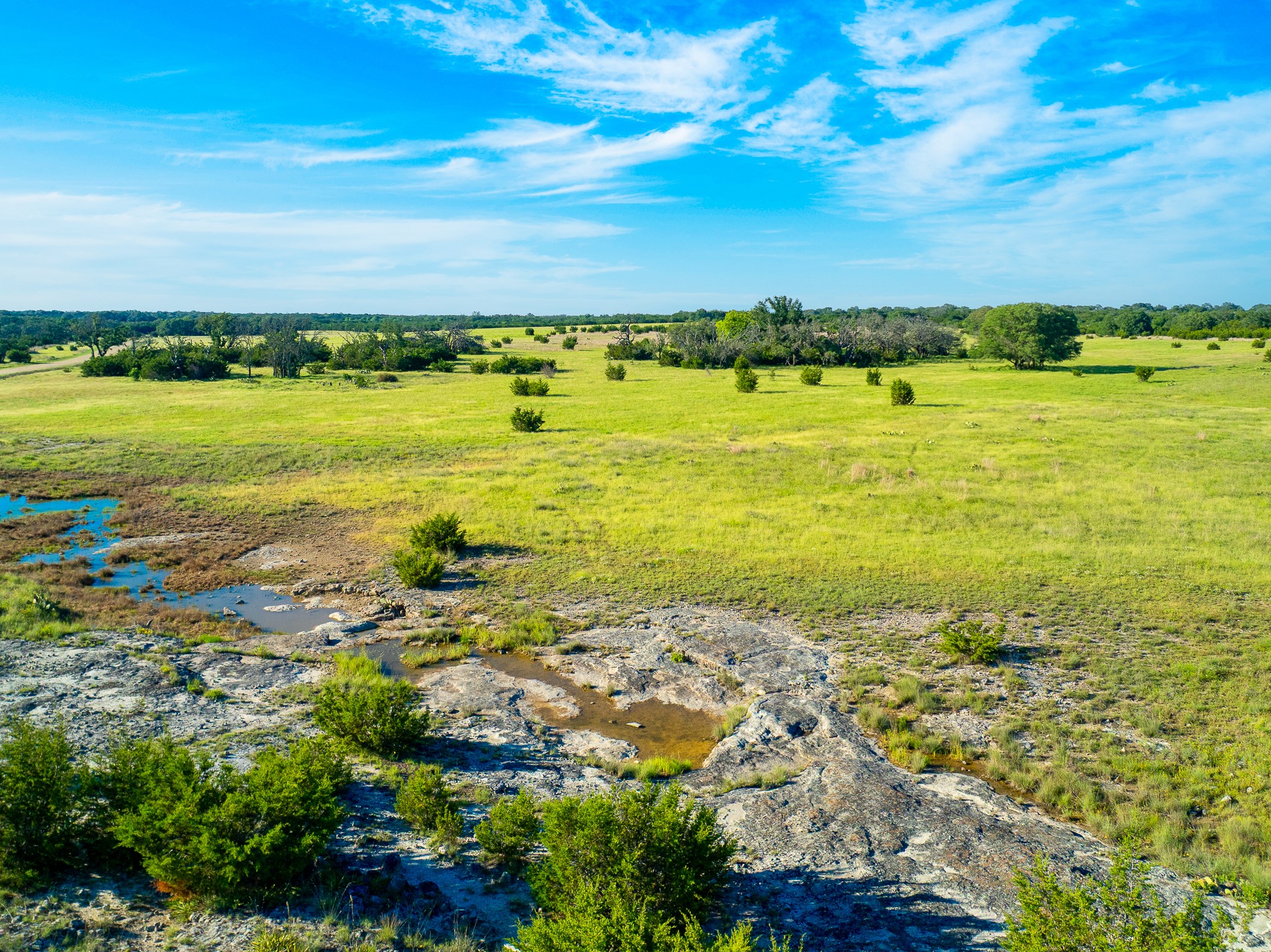 32 Feild Ranch Road Burnet, TX 78611 - Photo 31 of 40 Vast, open terrain featuring natural rock formations and abundant greenery under a boundless sky.
