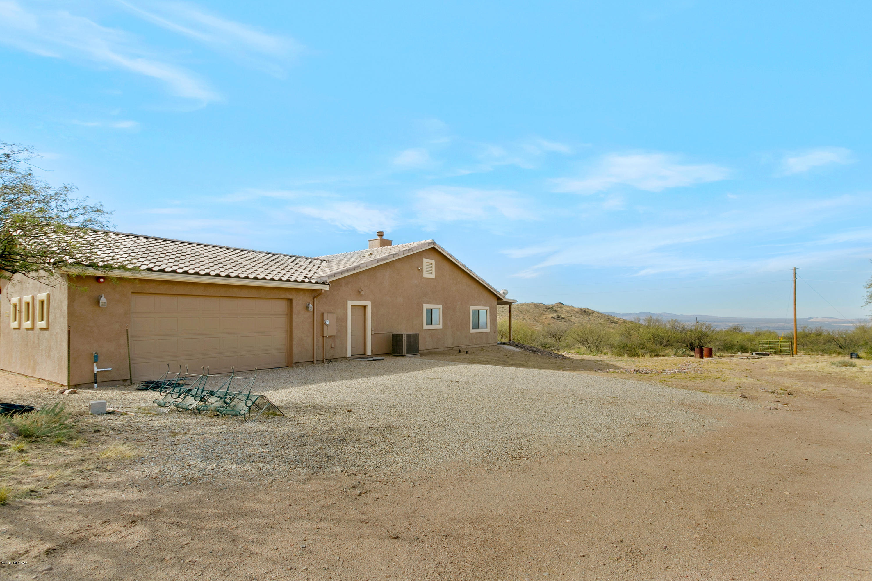 21960 South Helvetia Road Sahuarita, AZ 85629 - Photo 2 of 29 a front view of a house with a yard