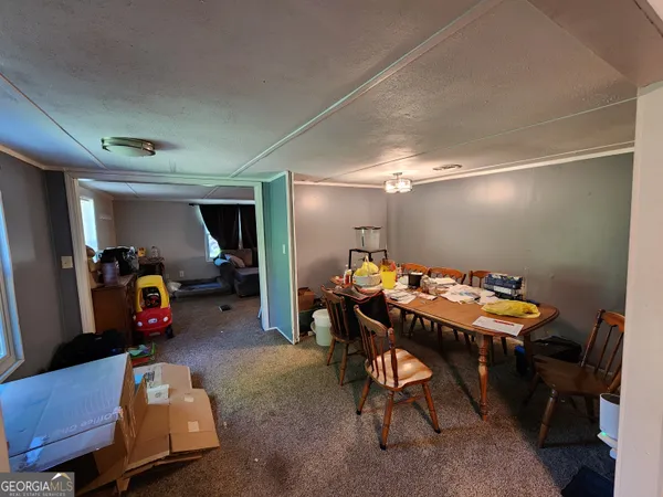 a view of a room that has a bed and a desk in it
