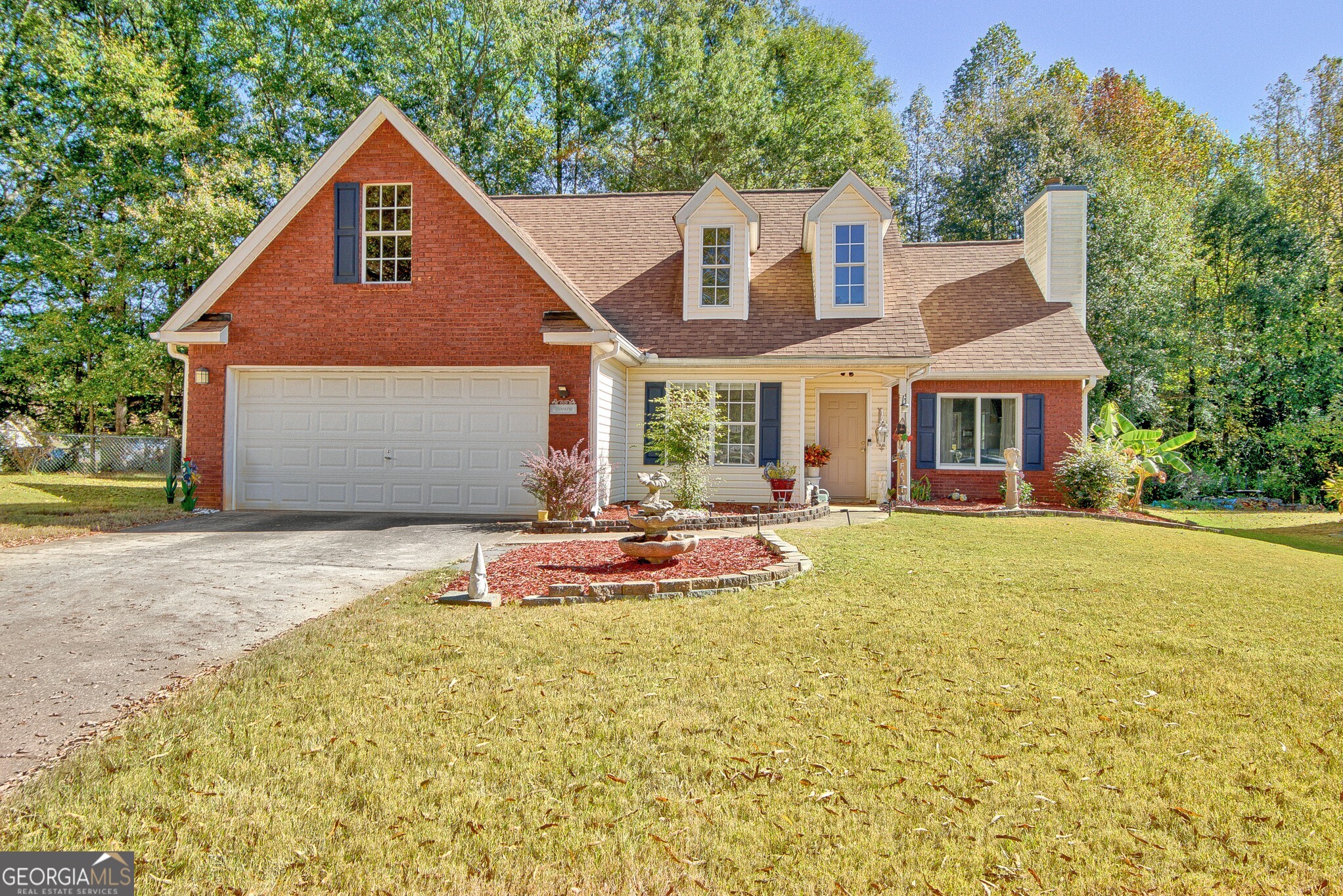 2040 Elm Grove Lane Hampton, GA 30228 - Photo 1 of 38 a view of a white house with a yard patio and a garden