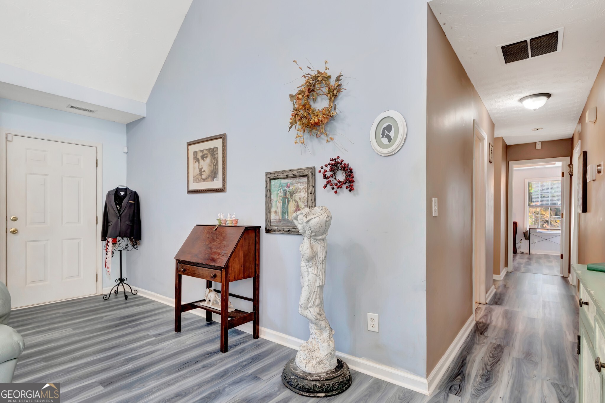 2040 Elm Grove Lane Hampton, GA 30228 - Photo 19 of 38 a view of a hallway with wooden floor and furniture
