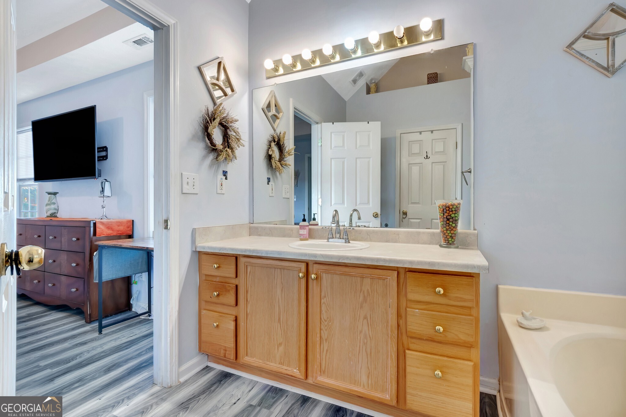 2040 Elm Grove Lane Hampton, GA 30228 - Photo 29 of 38 a spacious bathroom with a sink a mirror and a bathtub