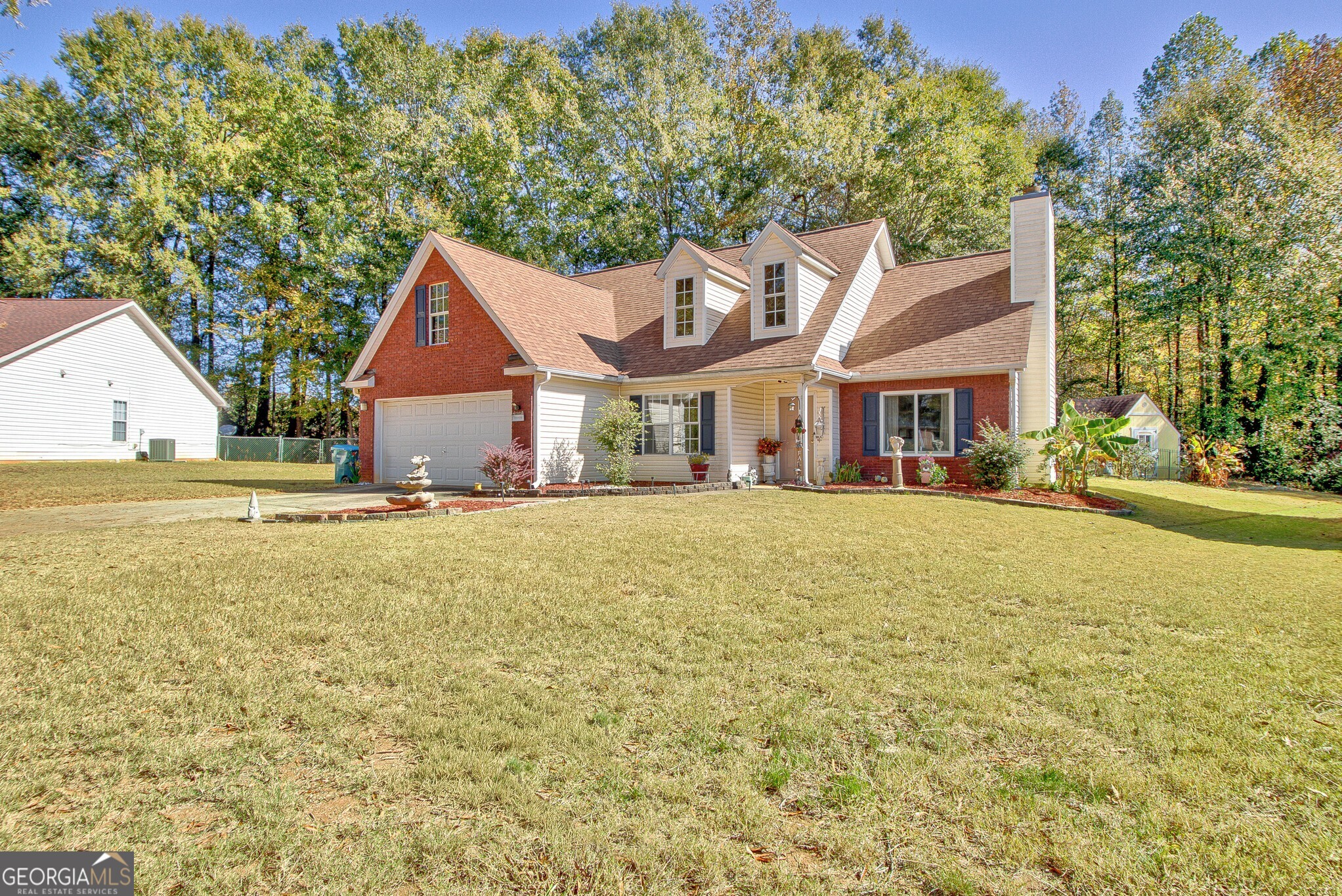 2040 Elm Grove Lane Hampton, GA 30228 - Photo 3 of 38 a house with a yard plants and large tree