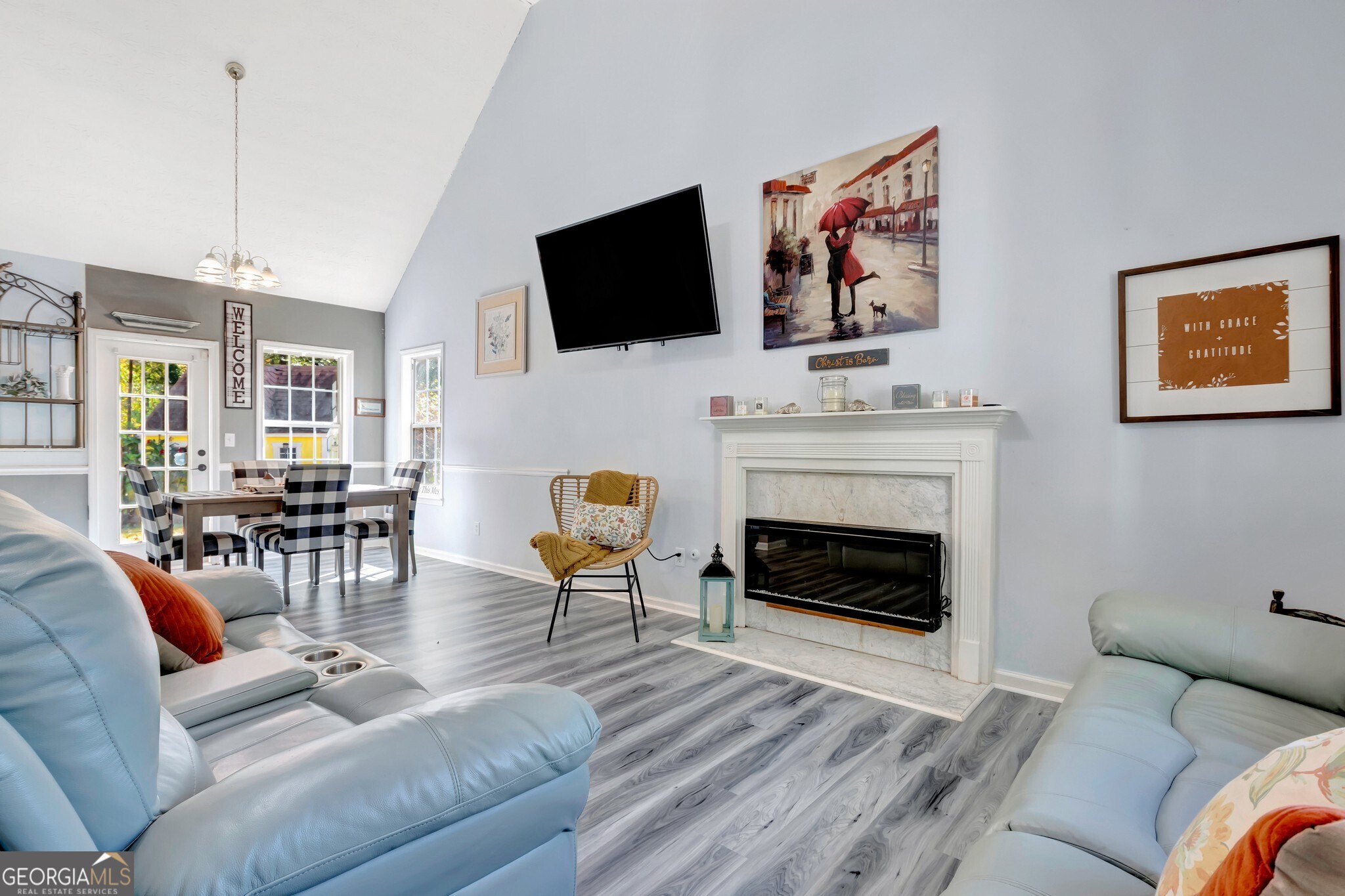 2040 Elm Grove Lane Hampton, GA 30228 - Photo 8 of 38 a living room with furniture a fireplace and a flat screen tv