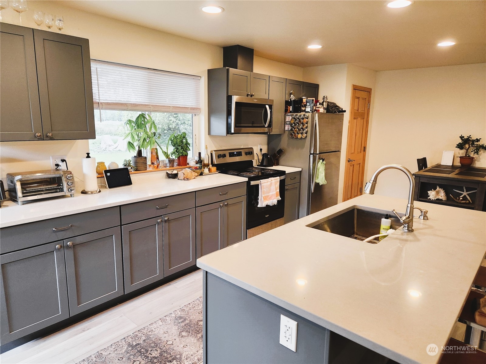 5314 Allison Road Bellingham, WA 98226 - Photo 8 of 29 a kitchen with a sink a stove and chairs