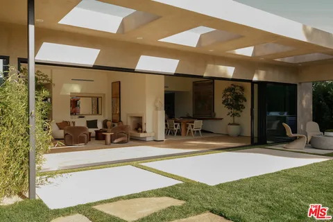 a view of a livingroom with dining space and a patio