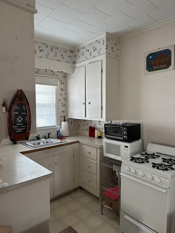9 Shea Street Salisbury, MA 01952 - Photo 5 of 8 a kitchen that has a sink and a stove in it