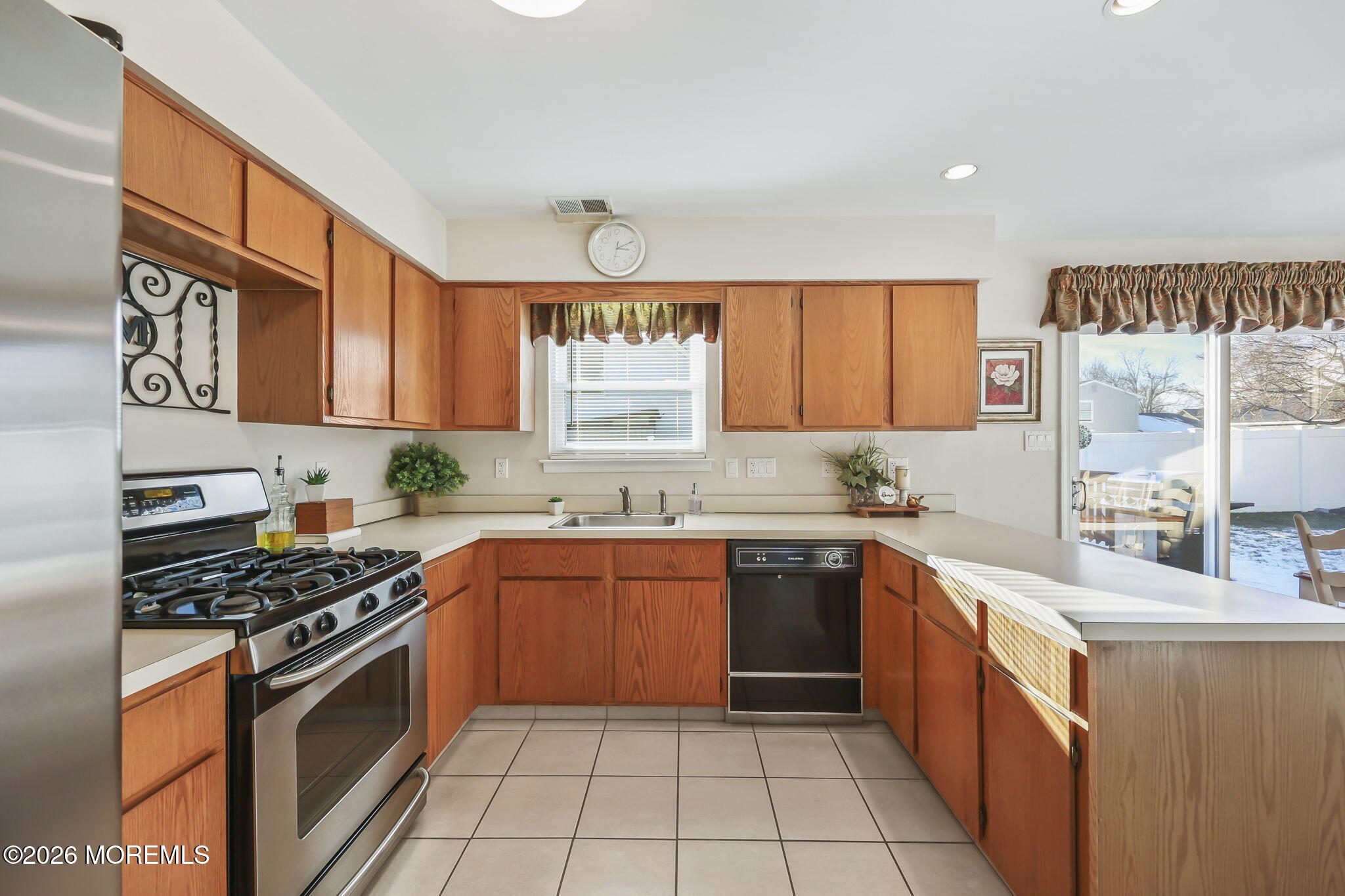 a kitchen with stainless steel appliances granite countertop a stove sink and cabinets