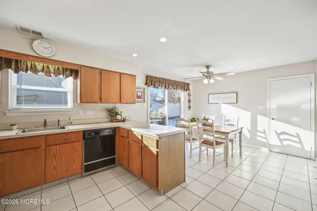 a kitchen with a sink and chairs