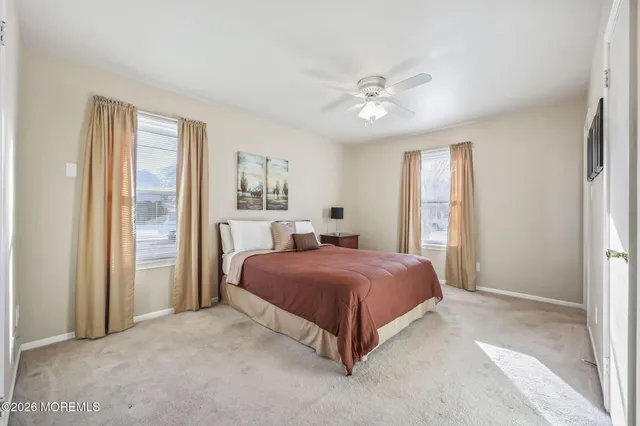 a spacious bedroom with a bed and a chandelier