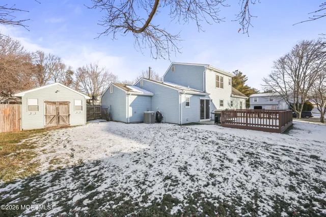 a view of a house with a yard covered in snow