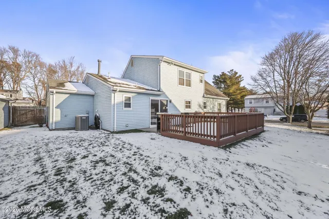 a view of a house with a wooden fence