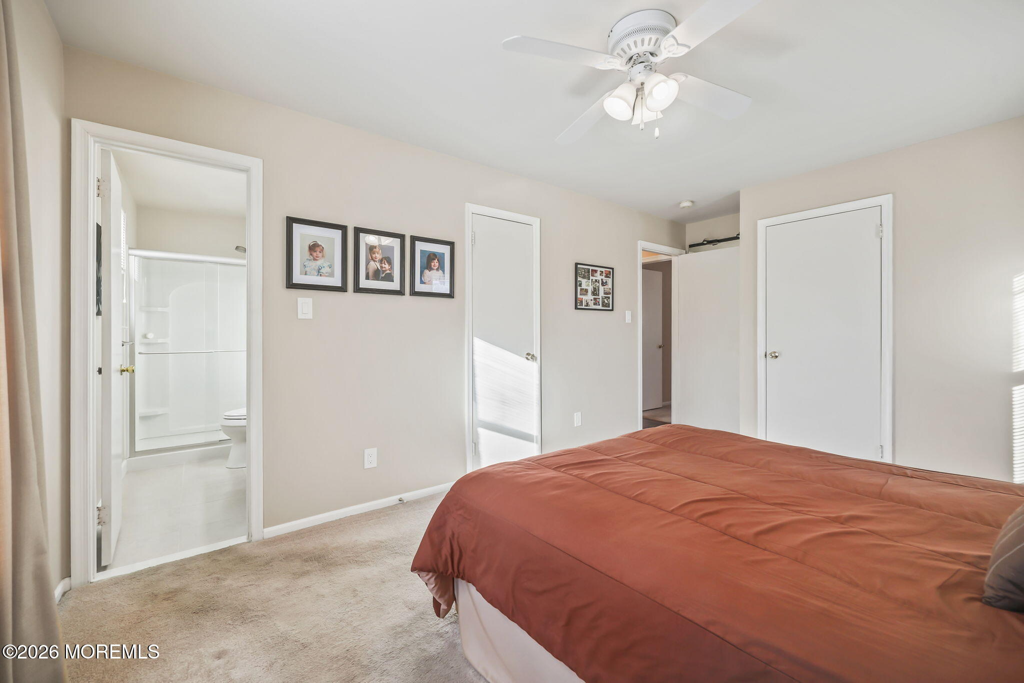 31 Sweetbriar Trail Howell, NJ 07731 - Photo 8 of 43 a bedroom with a large bed and a chandelier