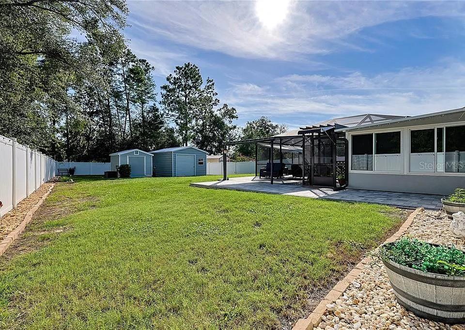 6367 Southwest 117th St Road Ocala, FL 34476 - Photo 20 of 22 a view of a house with backyard and sitting area