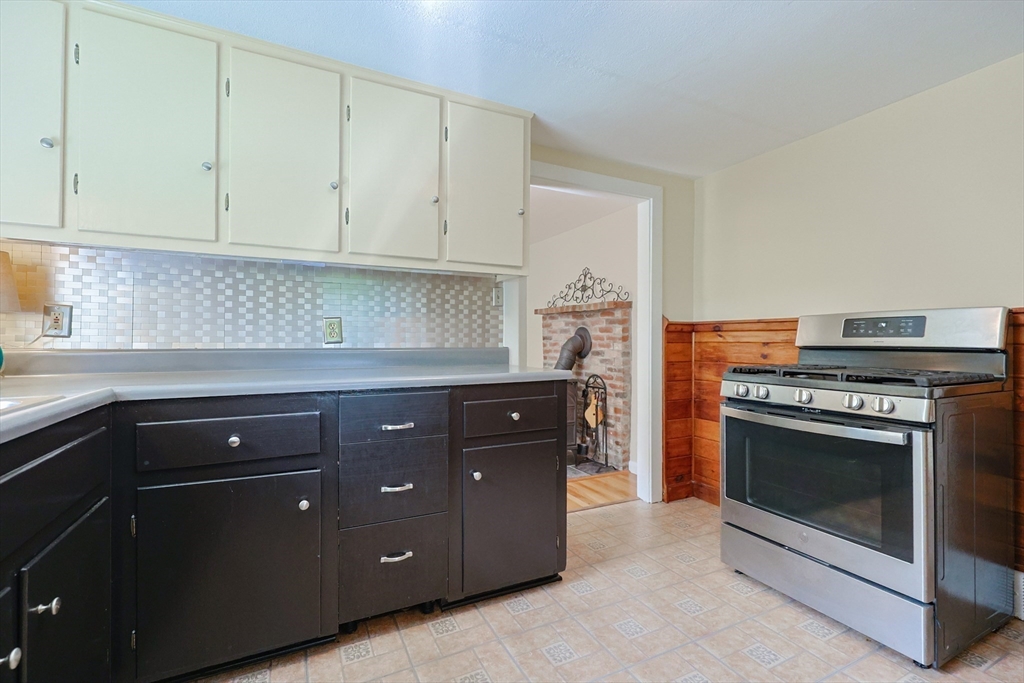 17 Chace Avenue Pepperell, MA 01463 - Photo 11 of 29 a kitchen with granite countertop white cabinets and stainless steel appliances