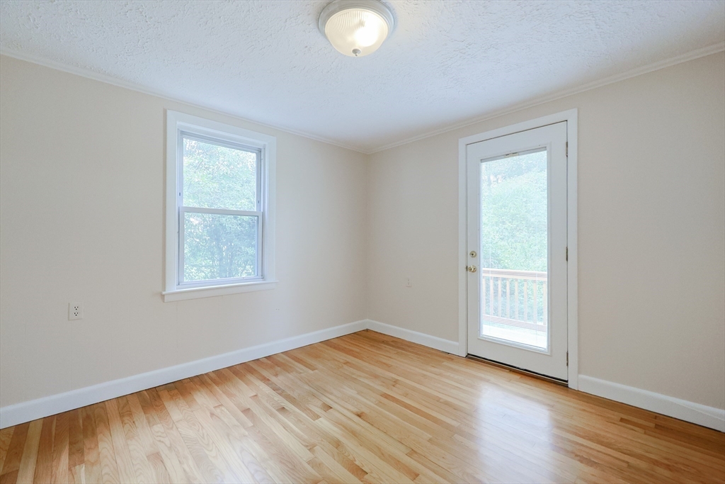 17 Chace Avenue Pepperell, MA 01463 - Photo 20 of 29 an empty room with wooden floor and windows