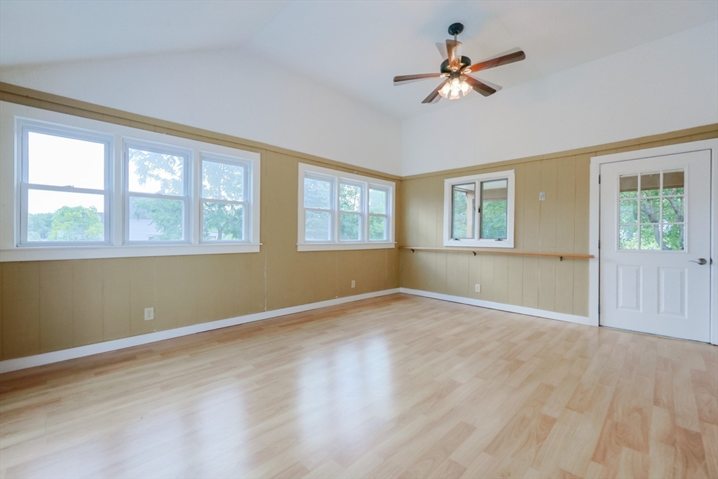 17 Chace Avenue Pepperell, MA 01463 - Photo 8 of 29 an empty room with wooden floor and windows