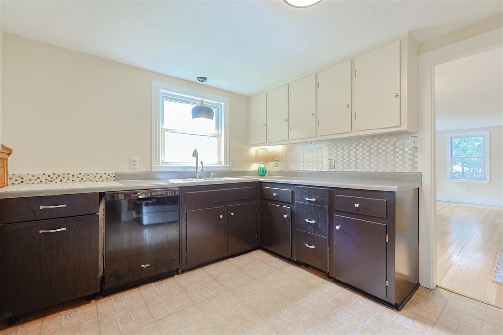 17 Chace Avenue Pepperell, MA 01463 - Photo 9 of 29 a kitchen with granite countertop a sink cabinets and window