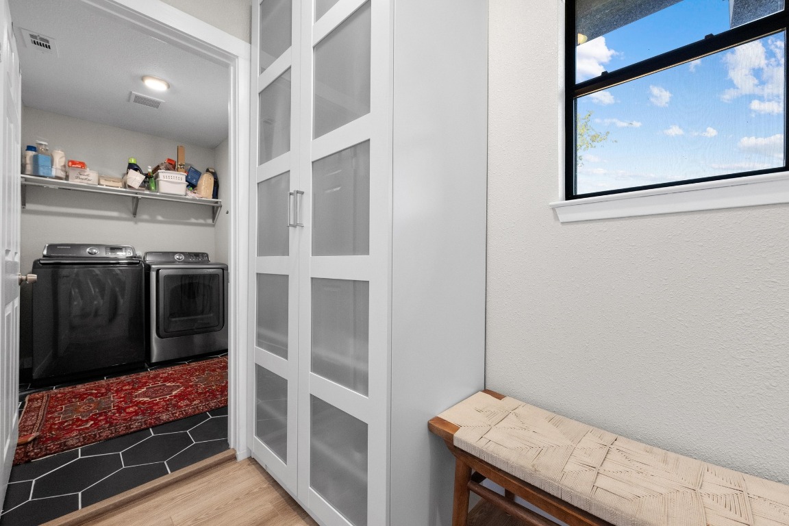 1006 Hollybluff Street Austin, TX 78753 - Photo 13 of 27 Laundry room with light wood-style floors and separate washer and dryer