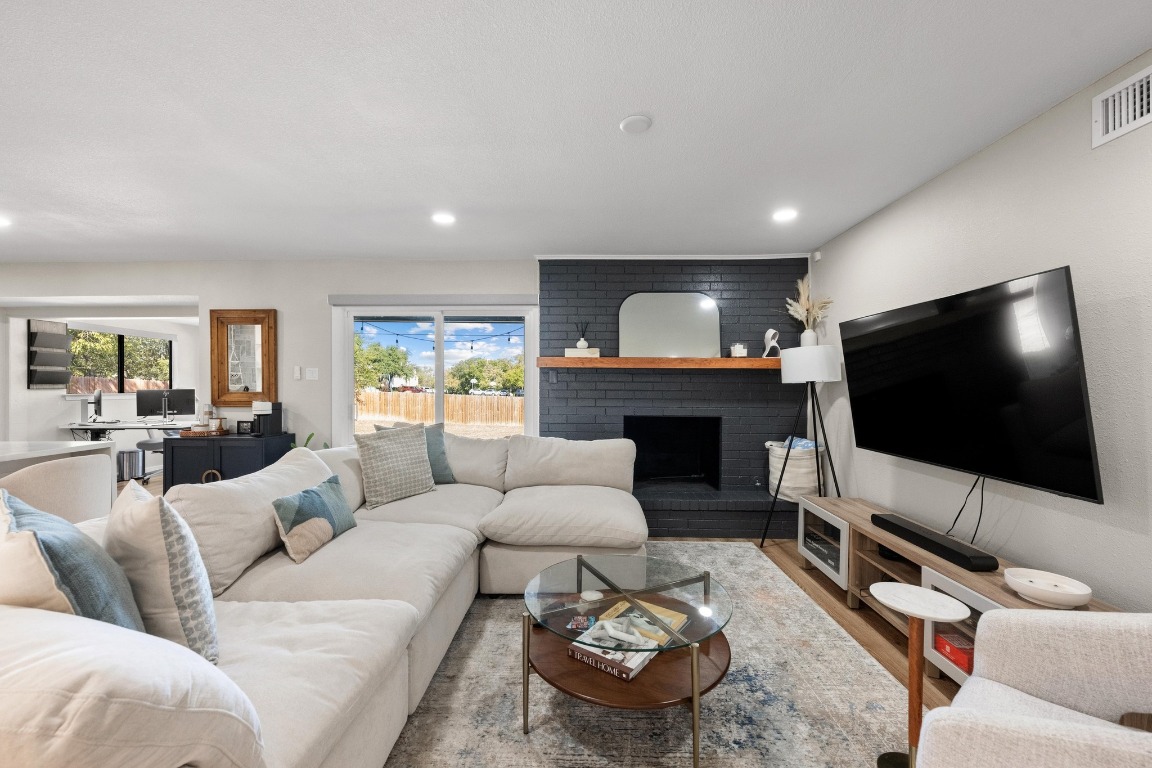 1006 Hollybluff Street Austin, TX 78753 - Photo 4 of 27 Living area with a fireplace, wood finished floors, and recessed lighting