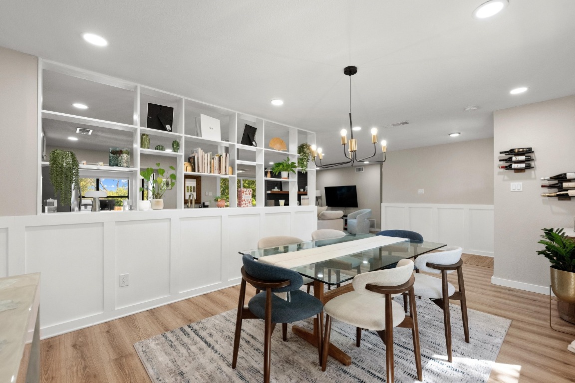 1006 Hollybluff Street Austin, TX 78753 - Photo 7 of 27 Dining space with a wainscoted wall, light wood-type flooring, recessed lighting, and a chandelier