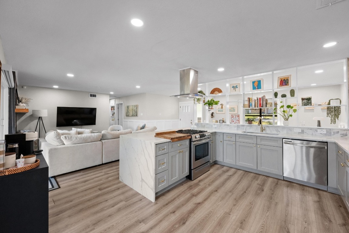 1006 Hollybluff Street Austin, TX 78753 - Photo 27 of 27 Kitchen featuring gray cabinets, open floor plan, a peninsula, stainless steel appliances, and recessed lighting