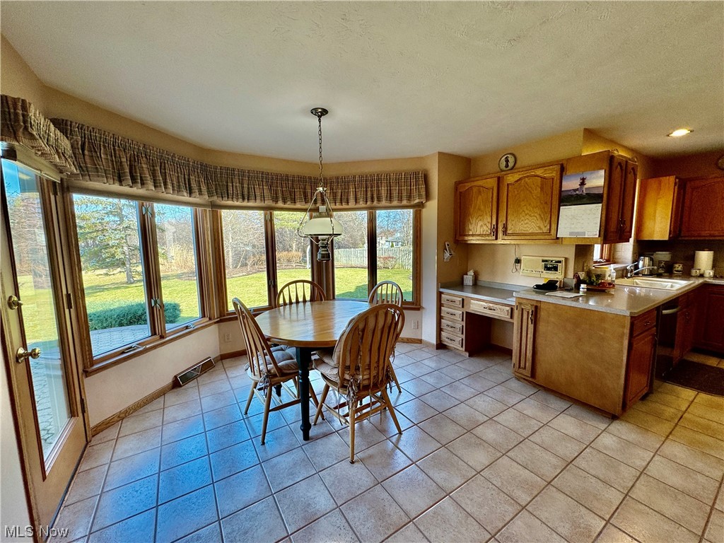 9615 Johnnycake Ridge Road Mentor, OH 44060 - Photo 5 of 35 Kitchen featuring a wealth of natural light, decorative light fixtures, and light tile floors