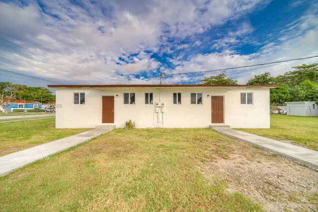 a view of house with backyard and garage