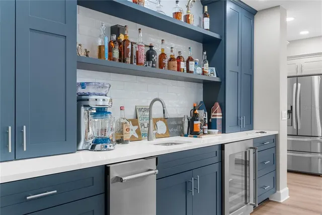 a kitchen with stainless steel appliances granite countertop a sink and cabinets
