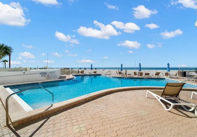 a view of a swimming pool and lounge chair