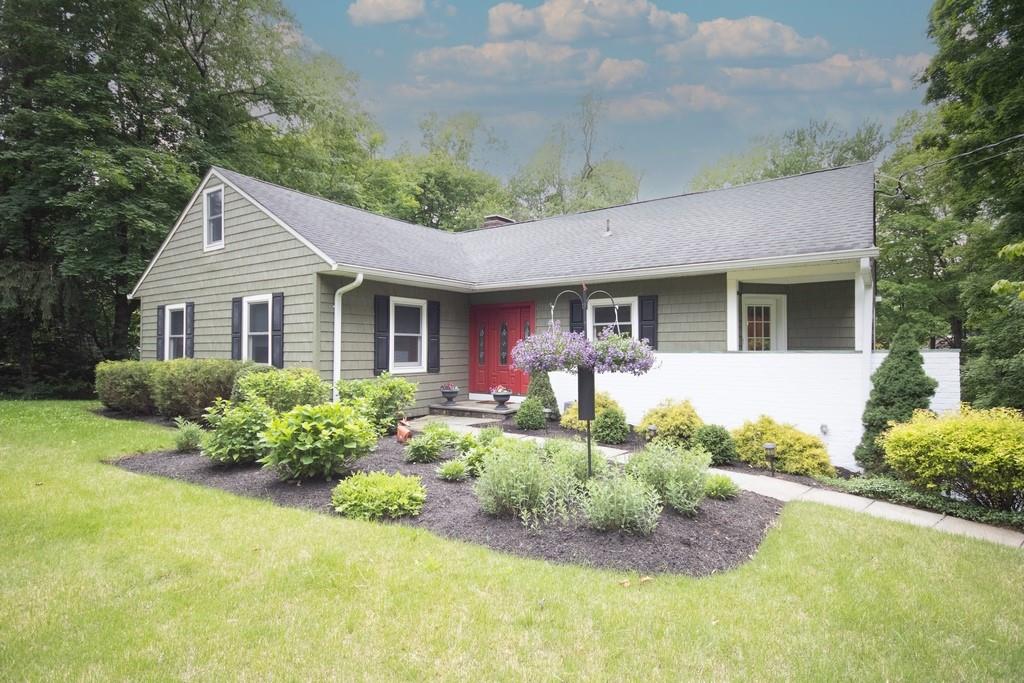 a front view of house with yard and green space