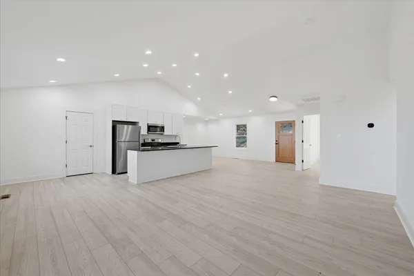 a kitchen with granite countertop a sink a stove and cabinets