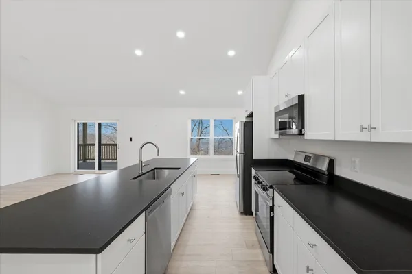 a kitchen with stainless steel appliances a refrigerator and a stove top oven