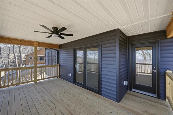 a view of a room with wooden floor and ceiling fan