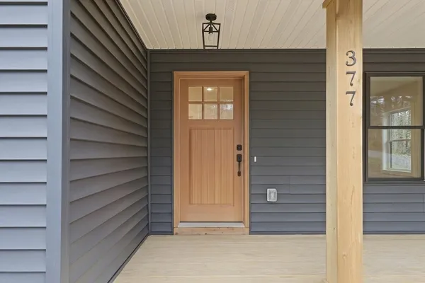a view of kitchen with microwave and cabinets