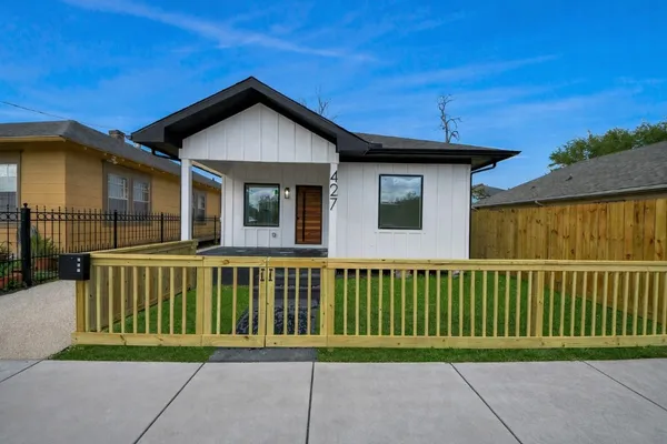a backyard of a house with table and chairs