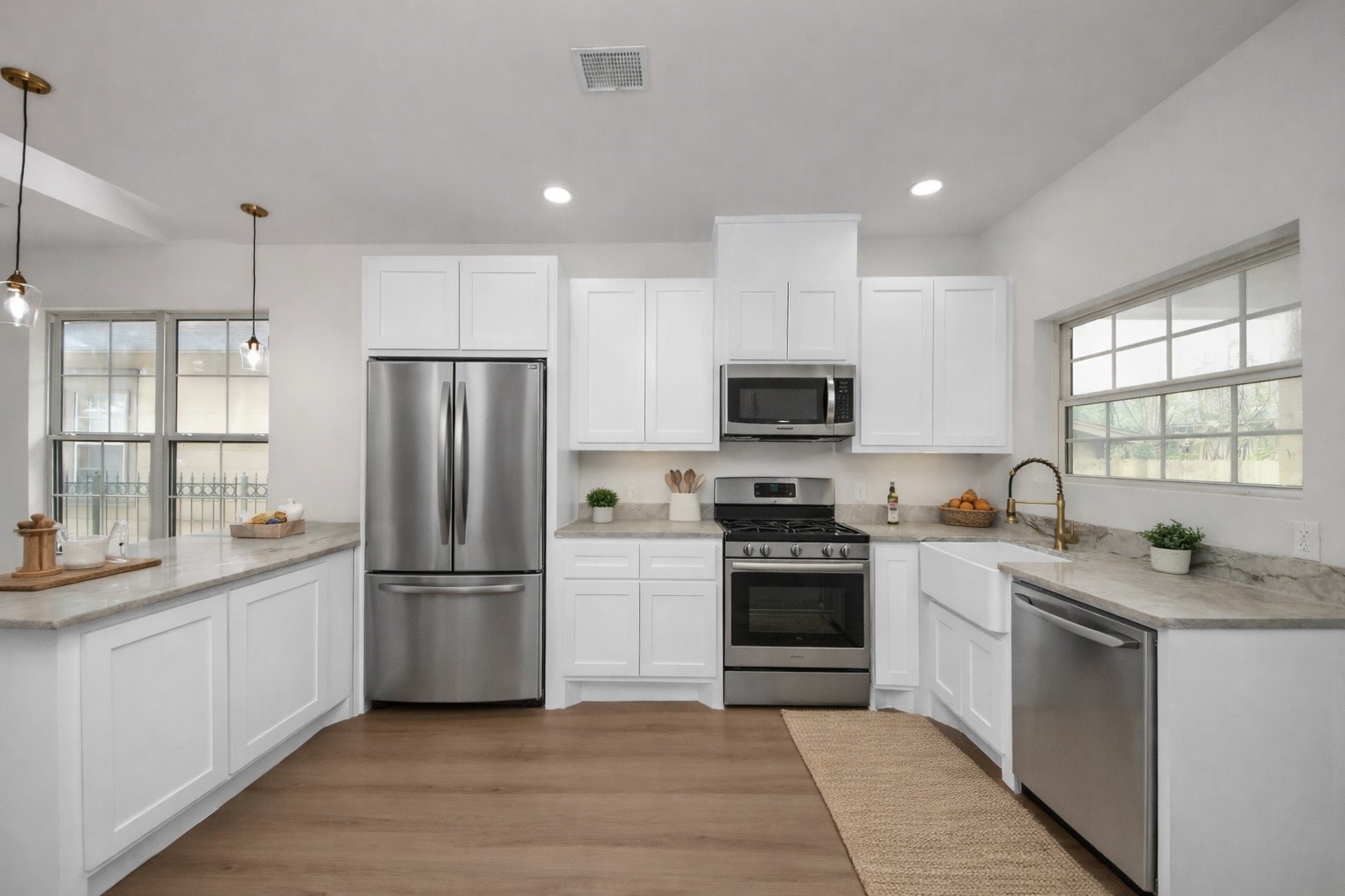 427 North Milby Street Houston, TX 77003 - Photo 7 of 44 a kitchen with a sink a refrigerator a microwave and cabinets