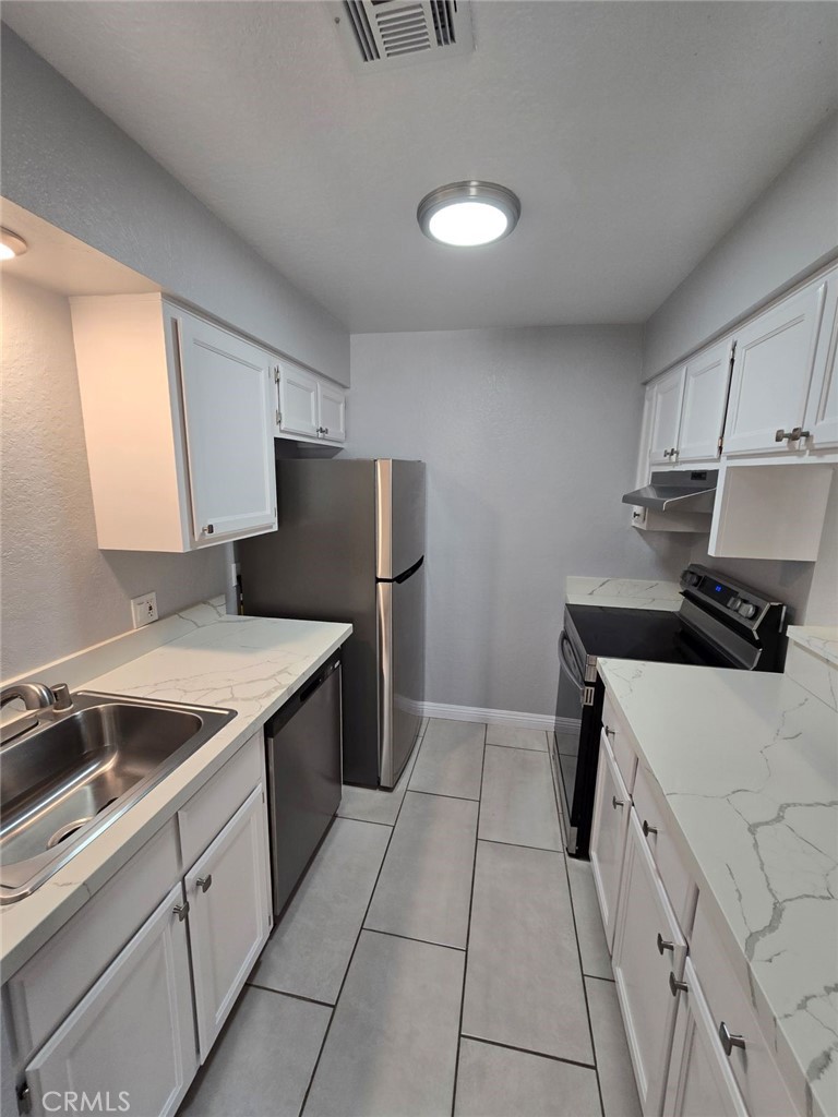 45200 Deep Canyon Road Palm Desert, CA 92260 - Photo 5 of 14 a kitchen with a stove cabinets and a refrigerator
